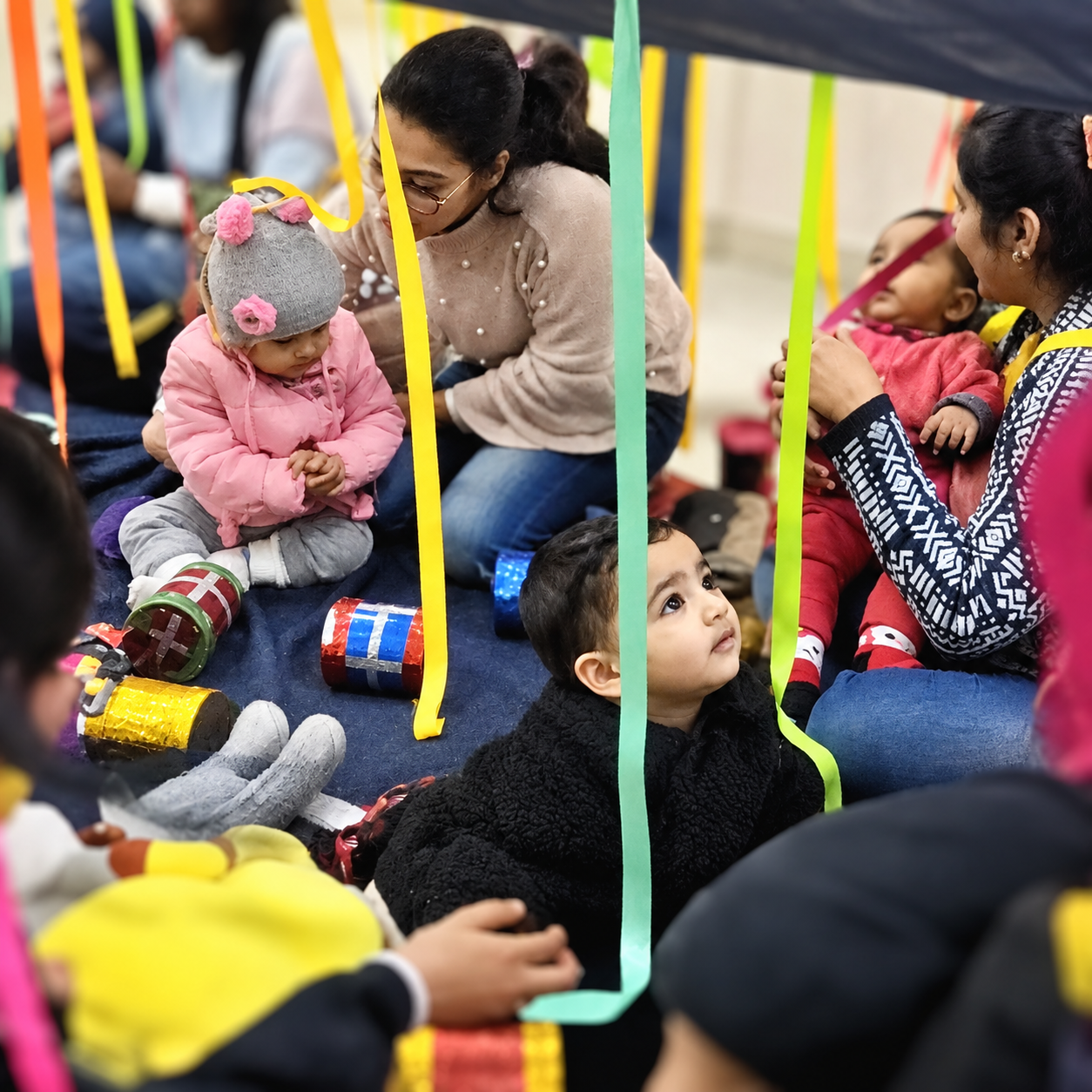 Curious toddler explores colorful ribbons-1 Educator Rohini Vij conducting an early years class