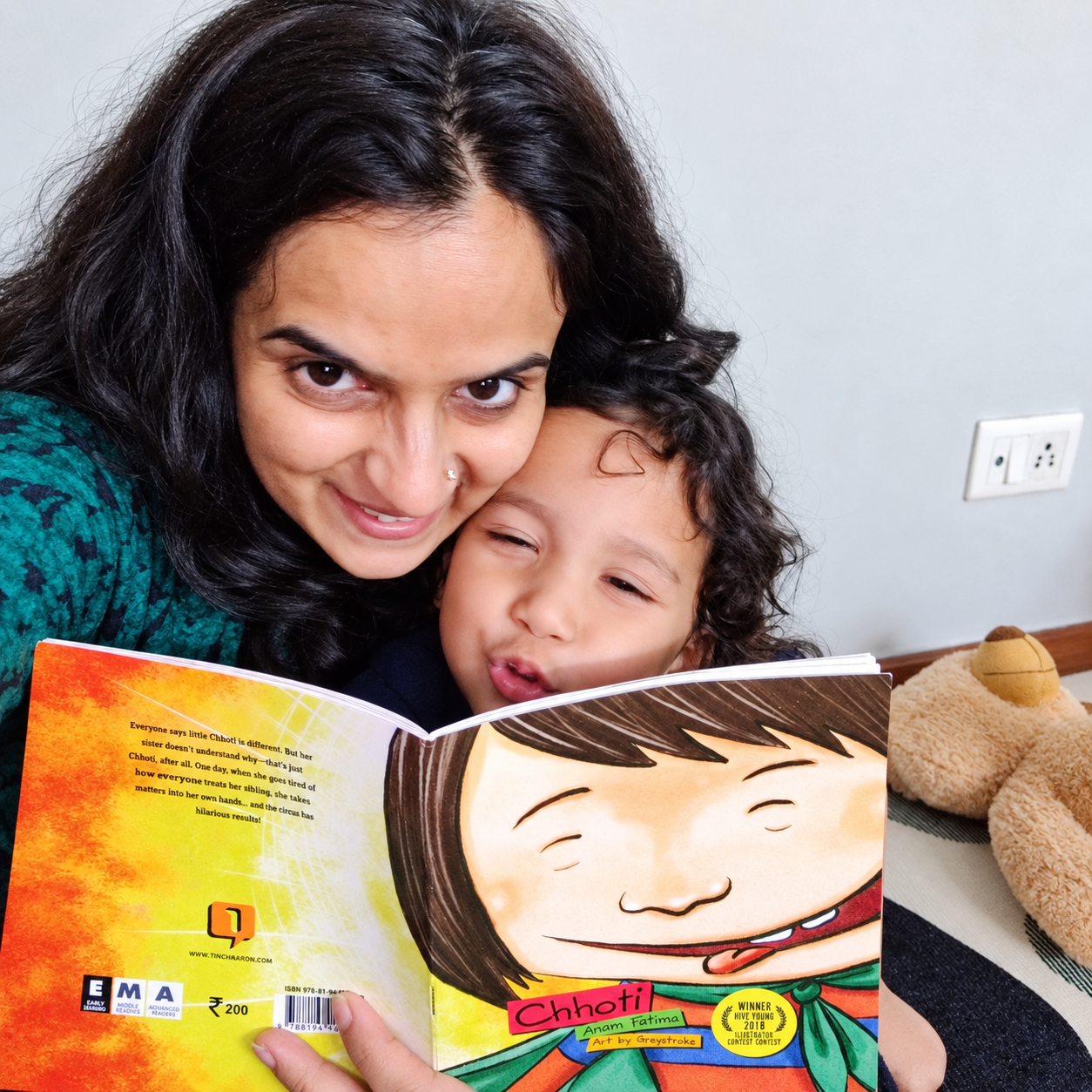 Mother and Child Reading a Colorful Book Mother and child reading a colourful book