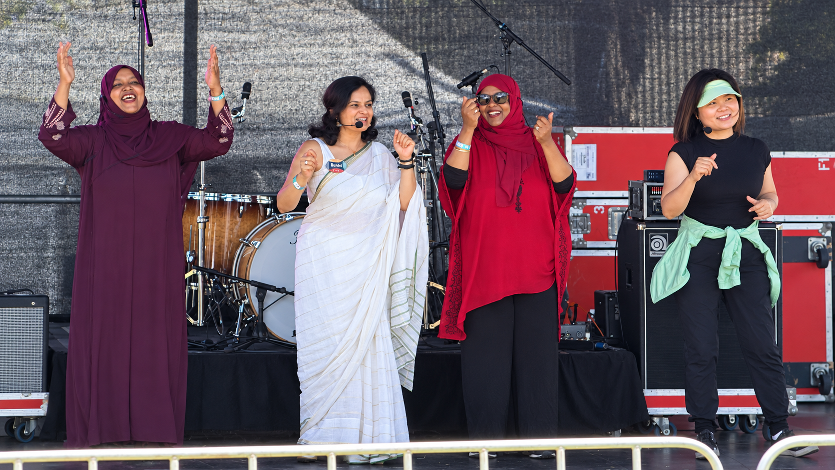 Rohini Vij and three fellow multicultural storytime storytellers performing together on stage at St Kilda Festival