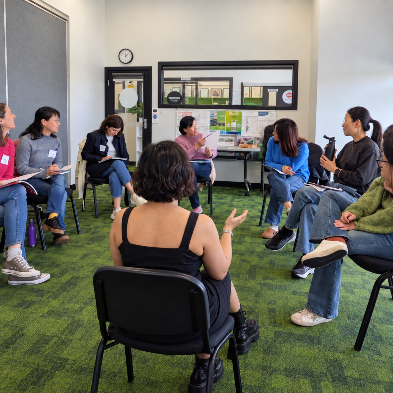 Rohini Vij, viewed from behind, facilitating a storytelling discussion with adults seated in a circle at Glen Eira Adult Learning Centre